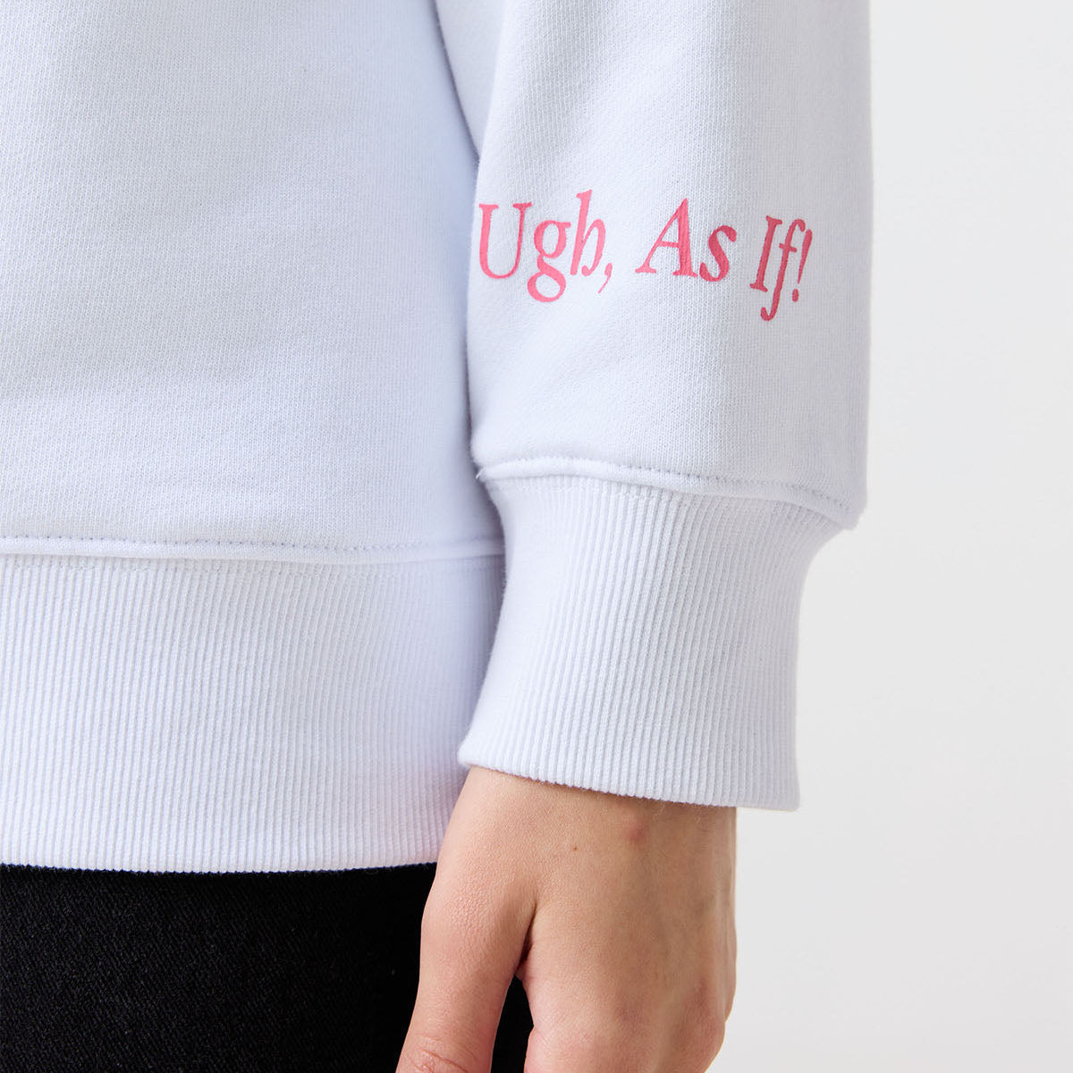 White sweatshirt sleeve with pink text 'Ugh, As If!' on a white background