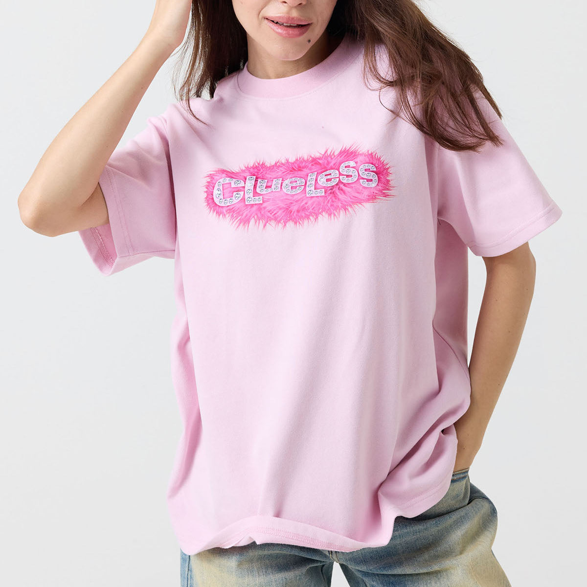 Person wearing a pink t-shirt with a logo on a white background