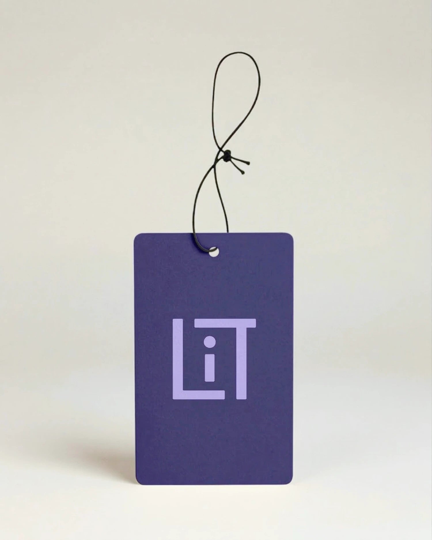 Purple air freshener with 'LIT' Literie logo on a light beige background