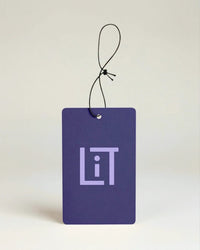 Purple air freshener with 'LIT' Literie logo on a light beige background