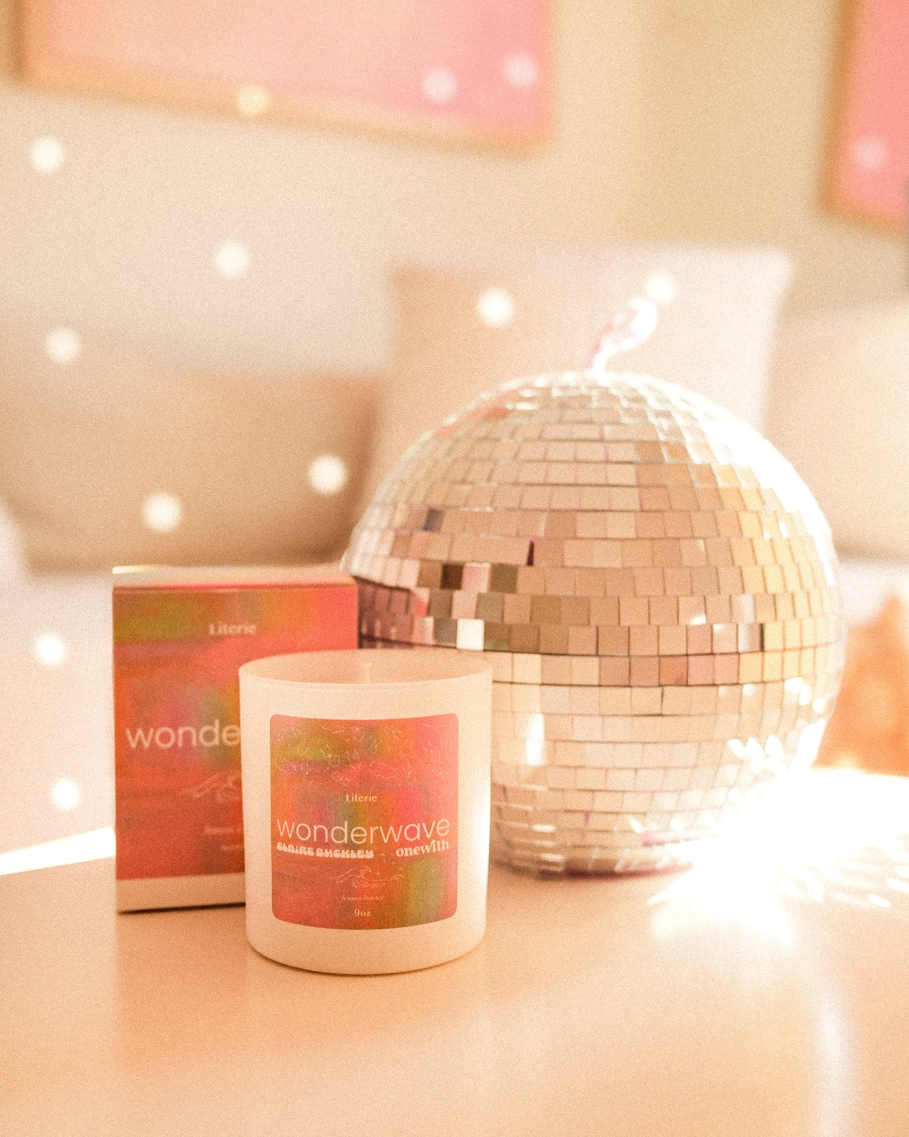 Wondewave candle by onewith x Claire Buckley next to a disco ball.