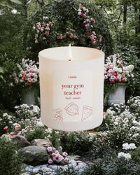 Candle that says "your gym teacher" on a floral background.